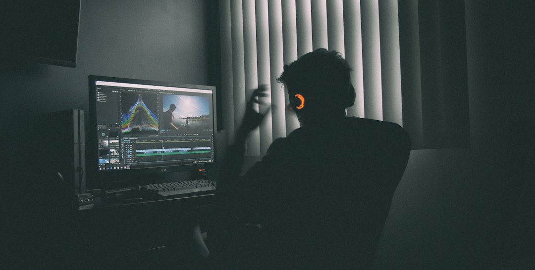 Content creator troubleshooting video editing software on a computer
